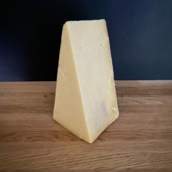 Keens Mature Cheddar larger wedge slant view scaled 1